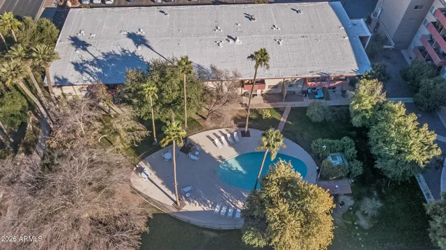 a swimming pool with outdoor seating and yard