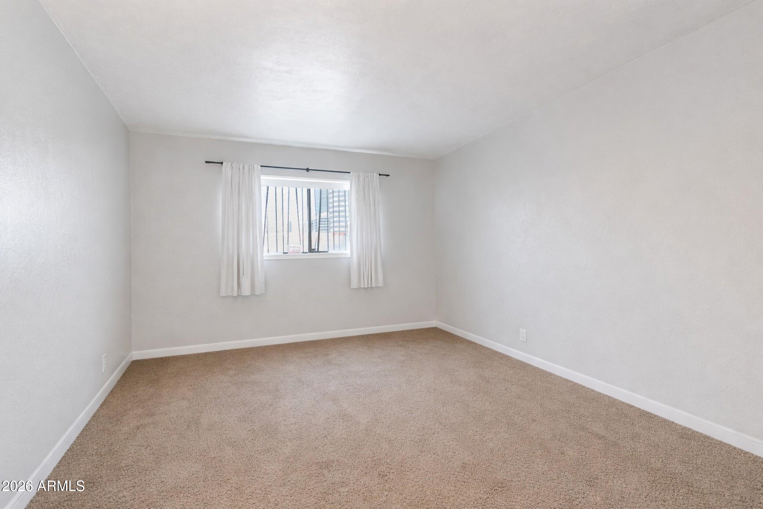 355 East Thomas Road, Unit B208 Phoenix, AZ 85004 - Photo 4 of 22 an empty room with a window