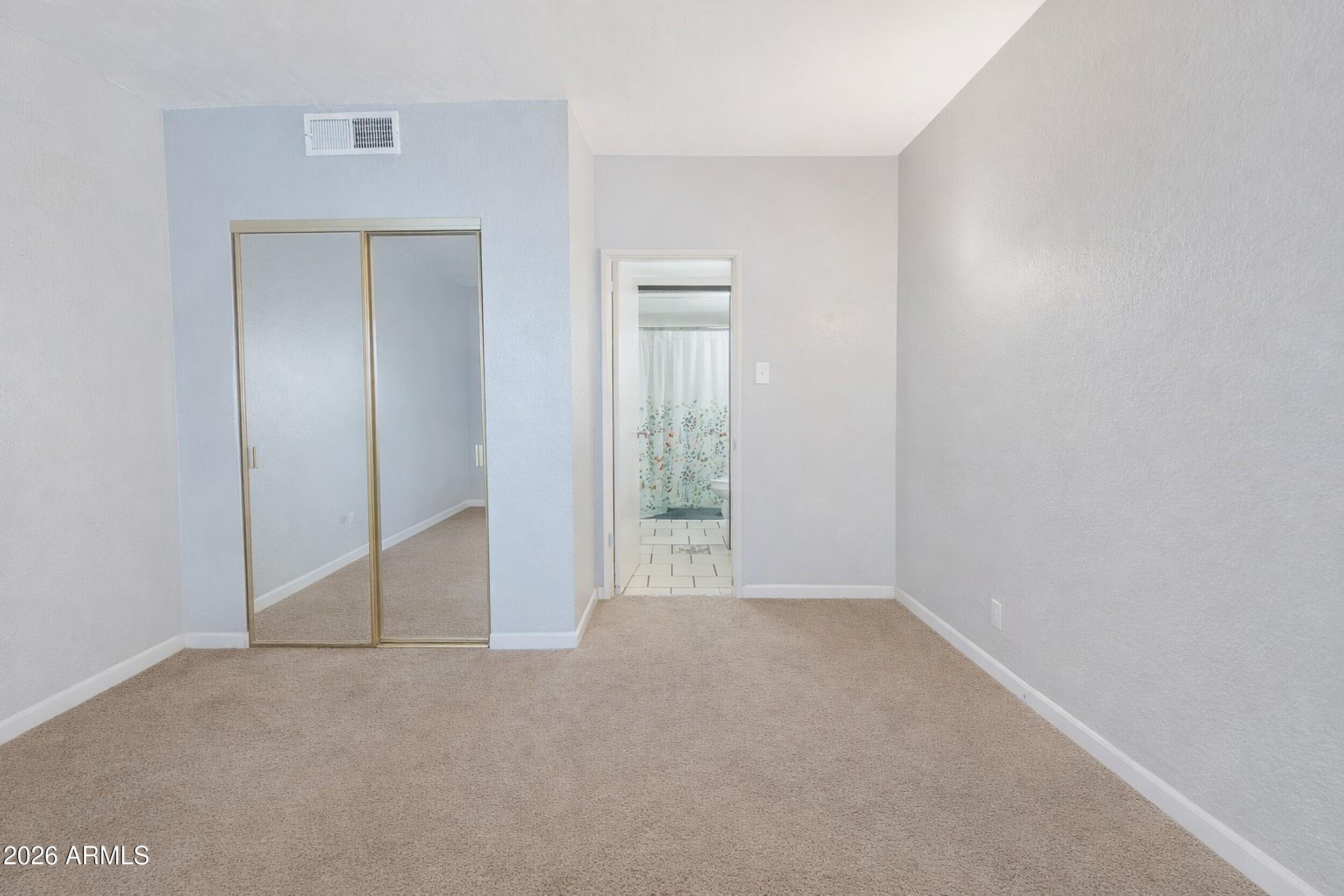 355 East Thomas Road, Unit B208 Phoenix, AZ 85004 - Photo 7 of 22 a view of an empty room with closet and mirror