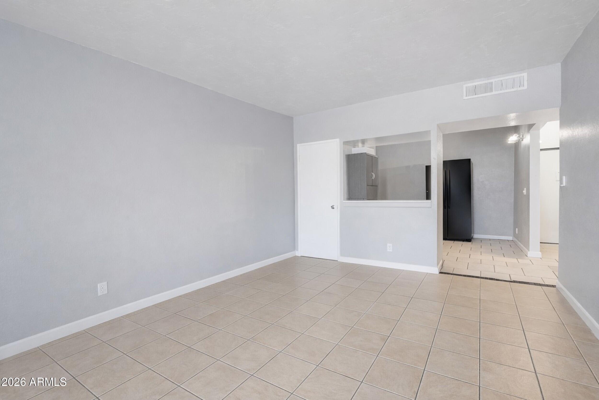 355 East Thomas Road, Unit B208 Phoenix, AZ 85004 - Photo 8 of 22 a view of a big room with wooden floor and windows