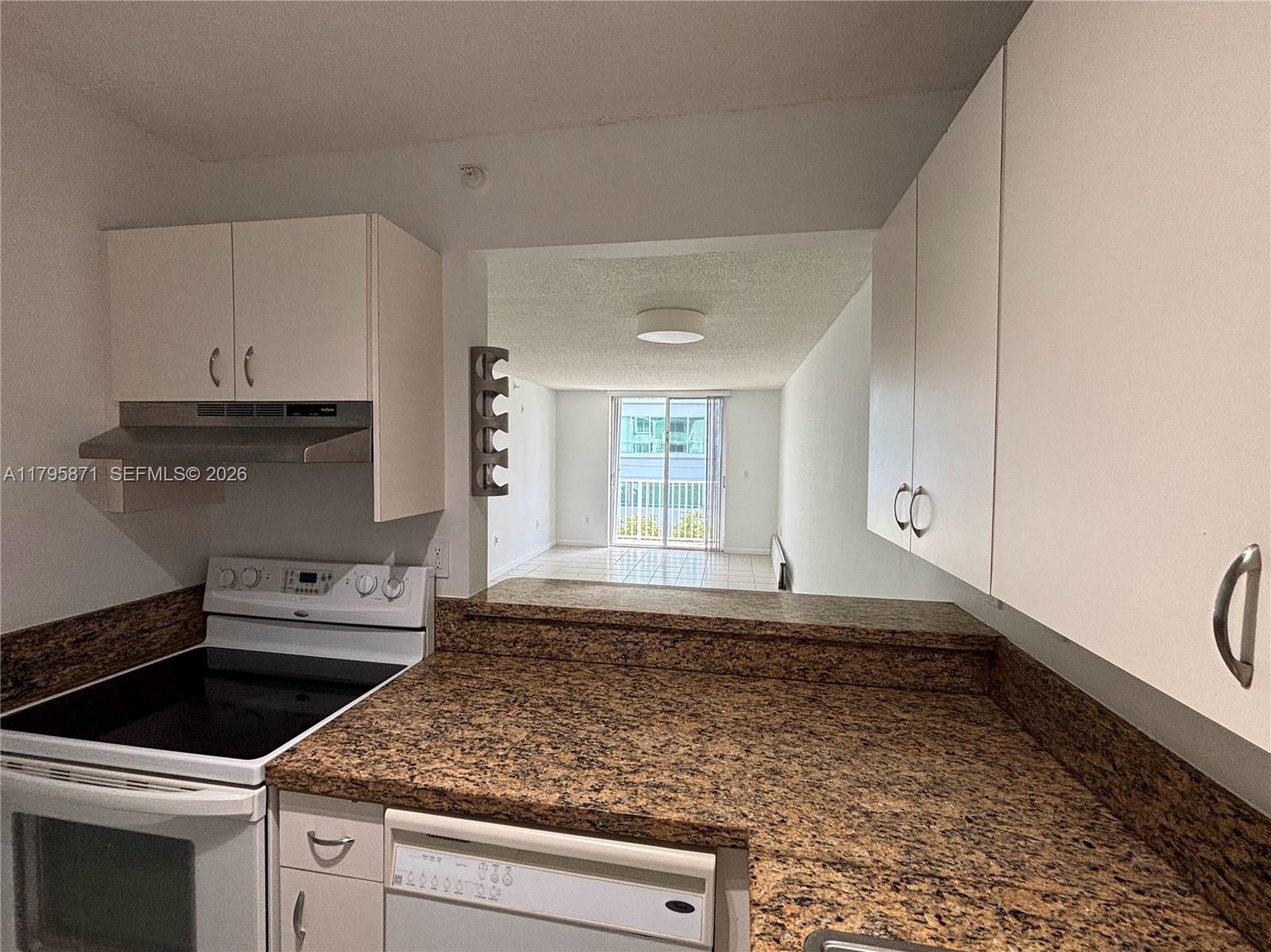126 Southwest 17th Road, Unit 505 Miami, FL 33129 - Photo 16 of 27 a kitchen with granite countertop a sink and a stove