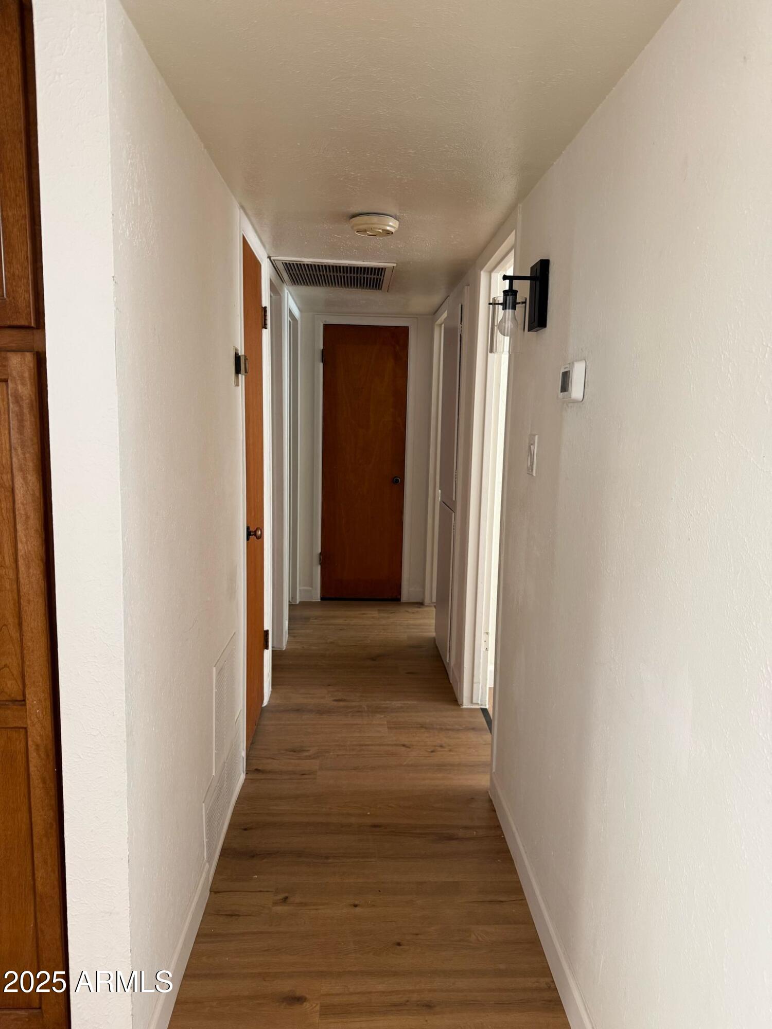 5000 West Osborn Road Phoenix, AZ 85031 - Photo 13 of 23 a view of a hallway with wooden floor