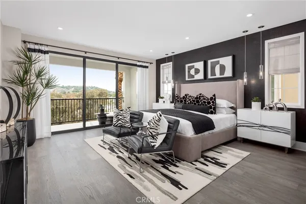 a bedroom with furniture and a large window