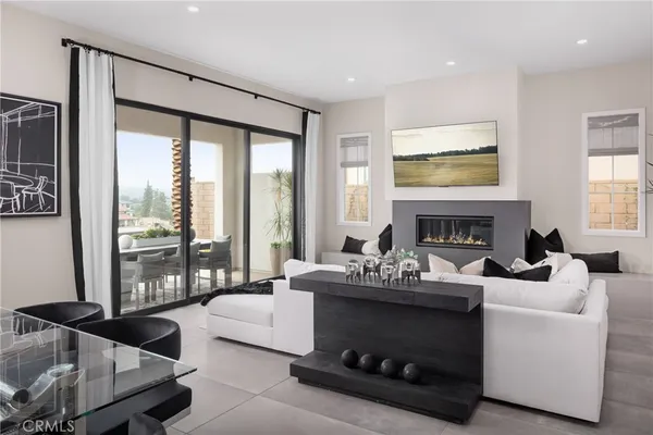 a living room with furniture a large window and a fireplace