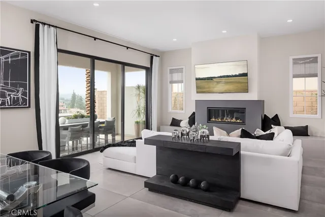 a living room with furniture a large window and a fireplace