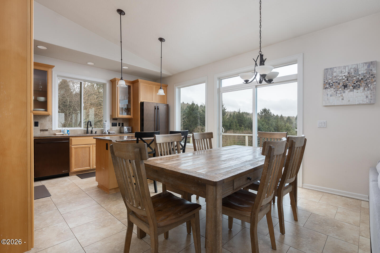 7415 East Summit Road Pacific City, OR 97135 - Photo 10 of 44 a dining room with furniture a chandelier and kitchen view