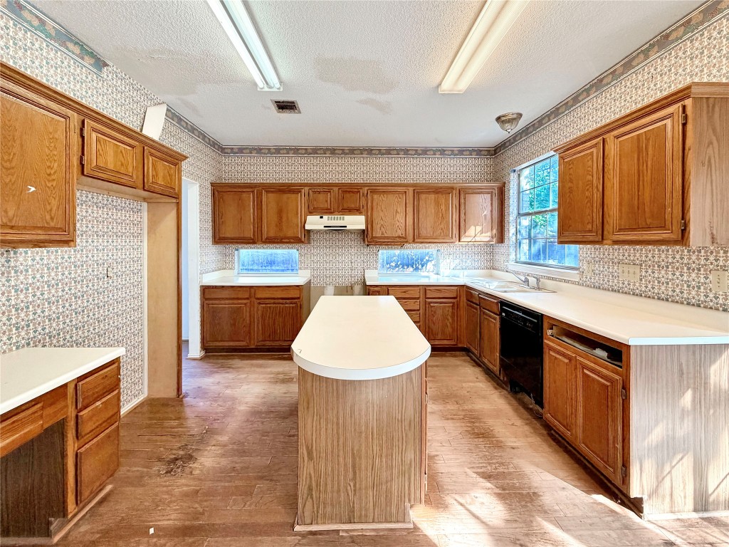 1106 Thistle Trail Cedar Park, TX 78613 - Photo 11 of 37 a kitchen with stainless steel appliances granite countertop a stove a sink dishwasher and a refrigerator