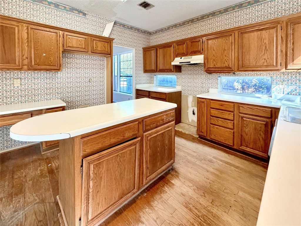 1106 Thistle Trail Cedar Park, TX 78613 - Photo 12 of 37 a kitchen with stainless steel appliances granite countertop a sink stove and cabinets