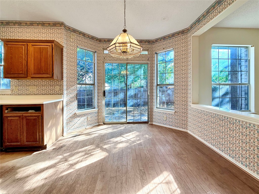 1106 Thistle Trail Cedar Park, TX 78613 - Photo 13 of 37 a view of an empty room with wooden floor and a window