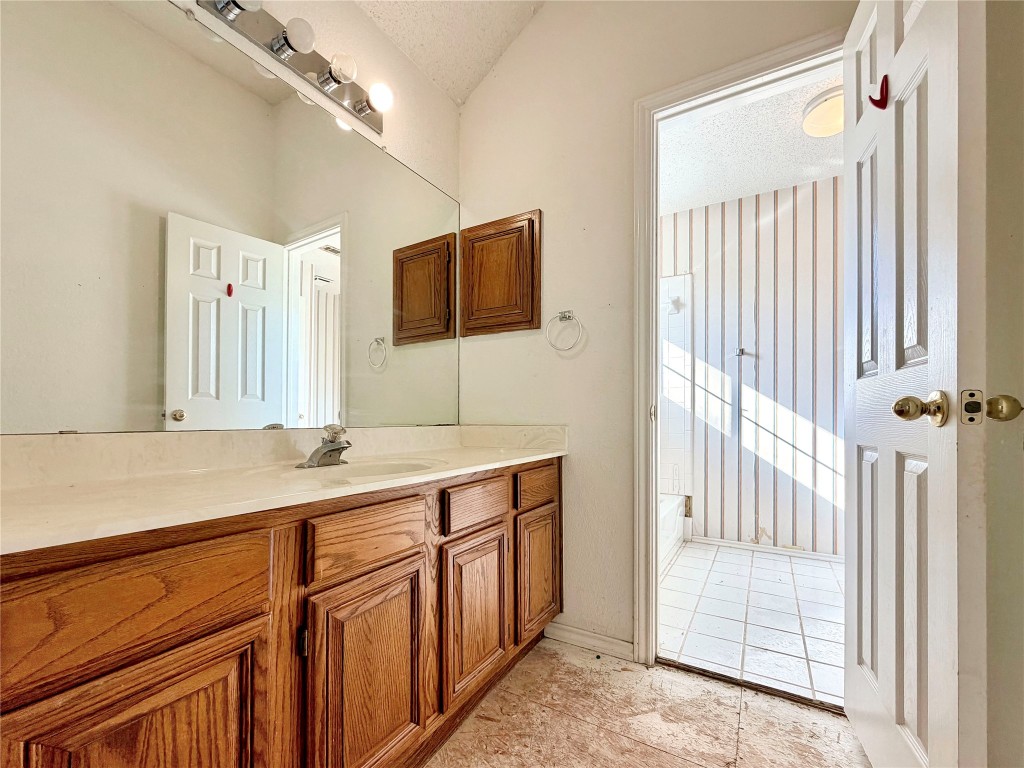 1106 Thistle Trail Cedar Park, TX 78613 - Photo 16 of 37 a bathroom with a sink a mirror and a shower