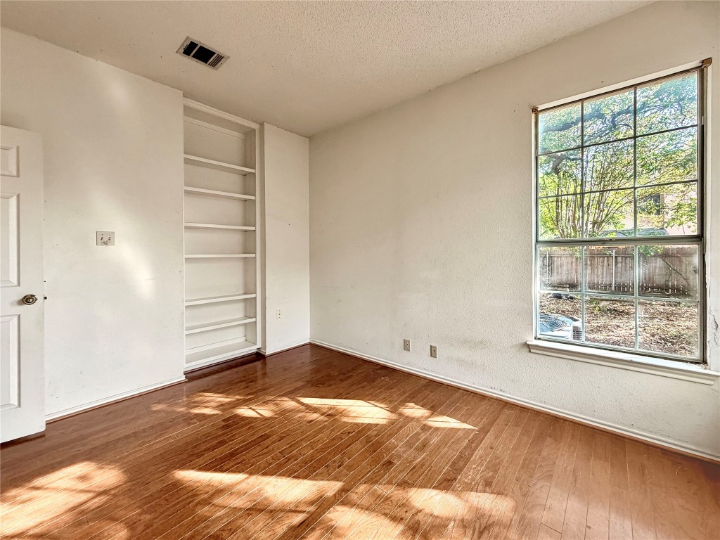1106 Thistle Trail Cedar Park, TX 78613 - Photo 22 of 37 a view of empty room with wooden floor and fan