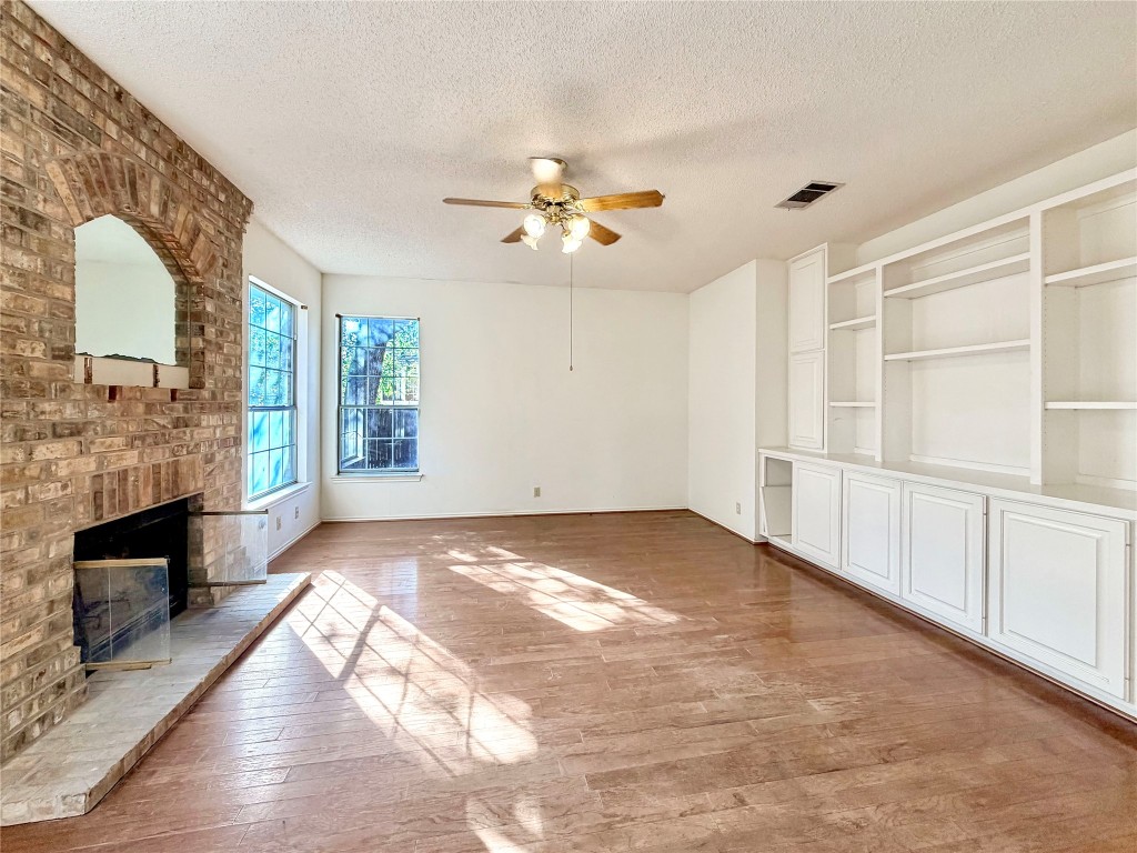 1106 Thistle Trail Cedar Park, TX 78613 - Photo 5 of 37 a view of an empty room with chandelier fan and wooden floor