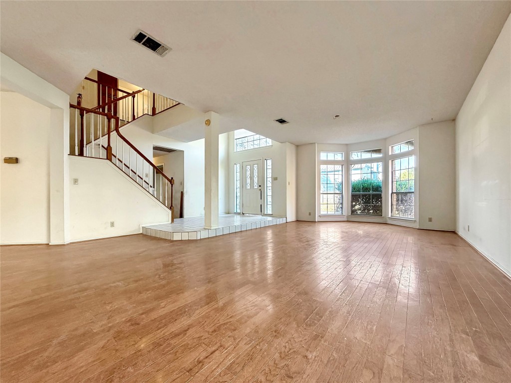 1106 Thistle Trail Cedar Park, TX 78613 - Photo 8 of 37 a view of an empty room with wooden floor and a window
