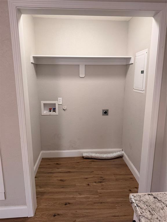 3714 Garden Lane Dallas, TX 75210 - Photo 3 of 7 Laundry area featuring electric dryer hookup, dark wood finished floors, electric panel, washer hookup, and hookup for a gas dryer