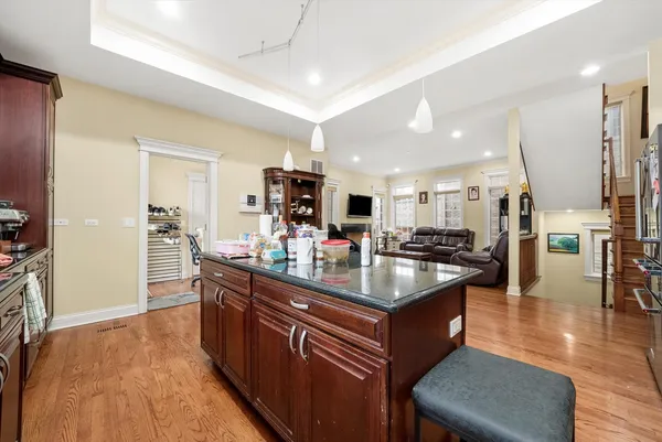 a kitchen with stainless steel appliances granite countertop a sink counter space and living room view