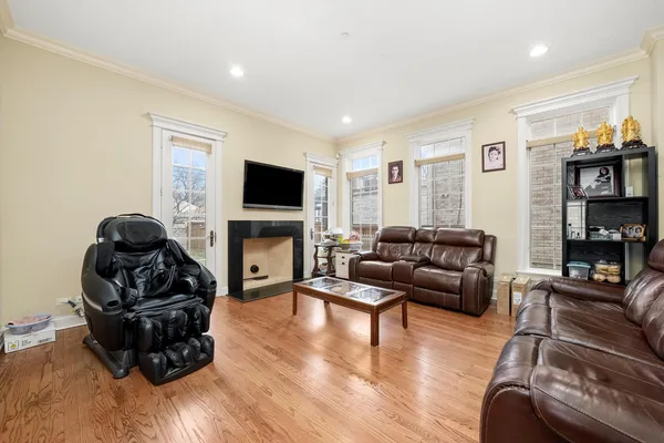 a living room with furniture a fireplace and a flat screen tv