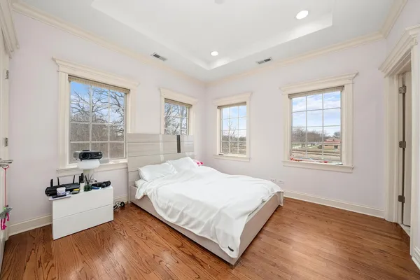a large bed sitting in a bedroom next to a window