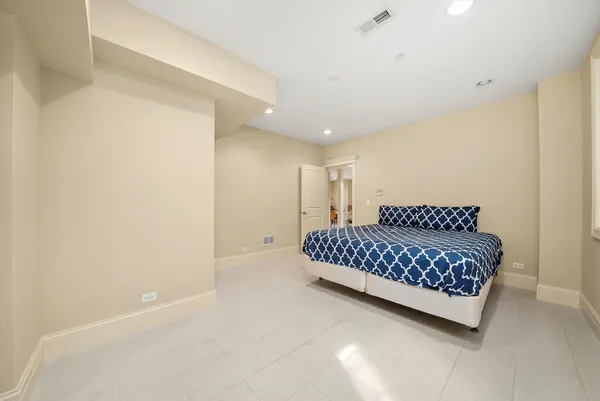 a spacious bedroom with a bed and a window