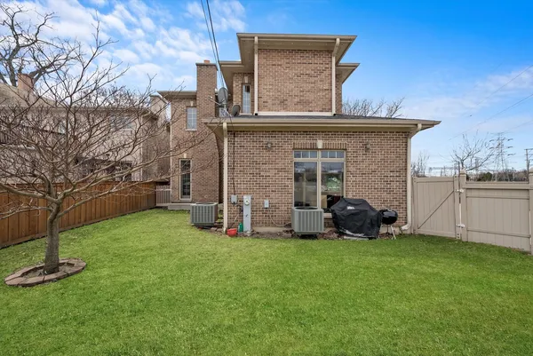 a view of a house with a yard and sitting area