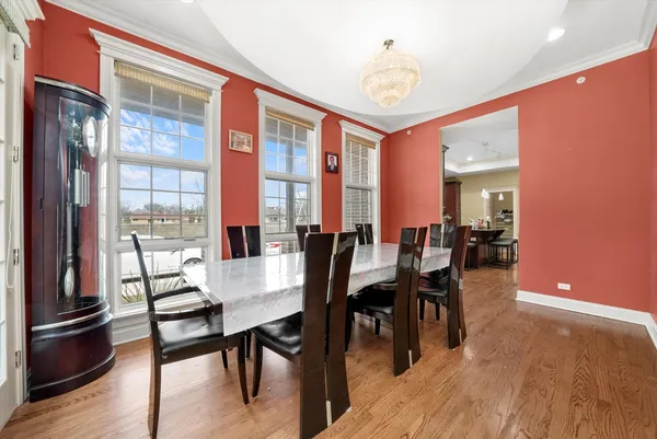 a dining room with furniture window and wooden floor