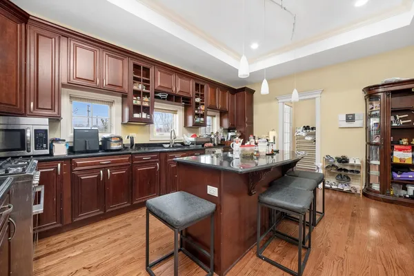 a kitchen with stainless steel appliances granite countertop a sink and wooden cabinets