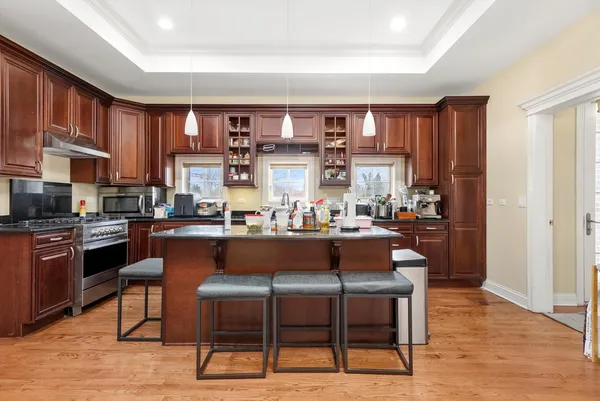 a living room with stainless steel appliances kitchen island granite countertop furniture and a kitchen view