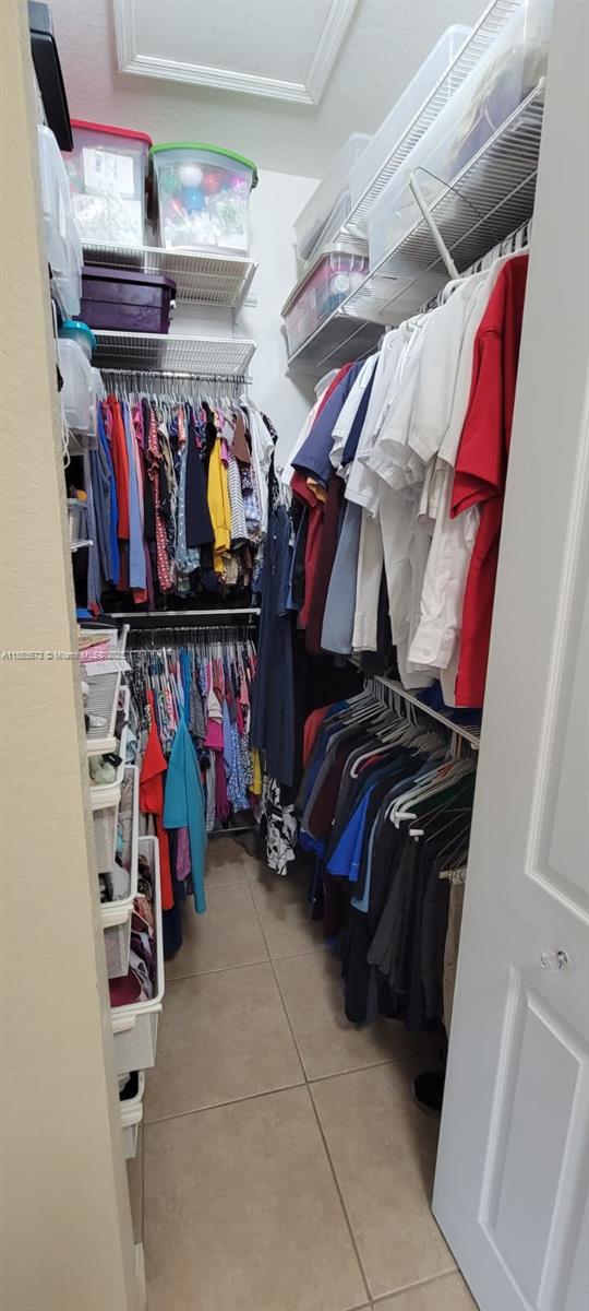 13281 Southwest 206th Terrace Miami, FL 33177 - Photo 13 of 18 a view of walk in closet with clothes and shoes
