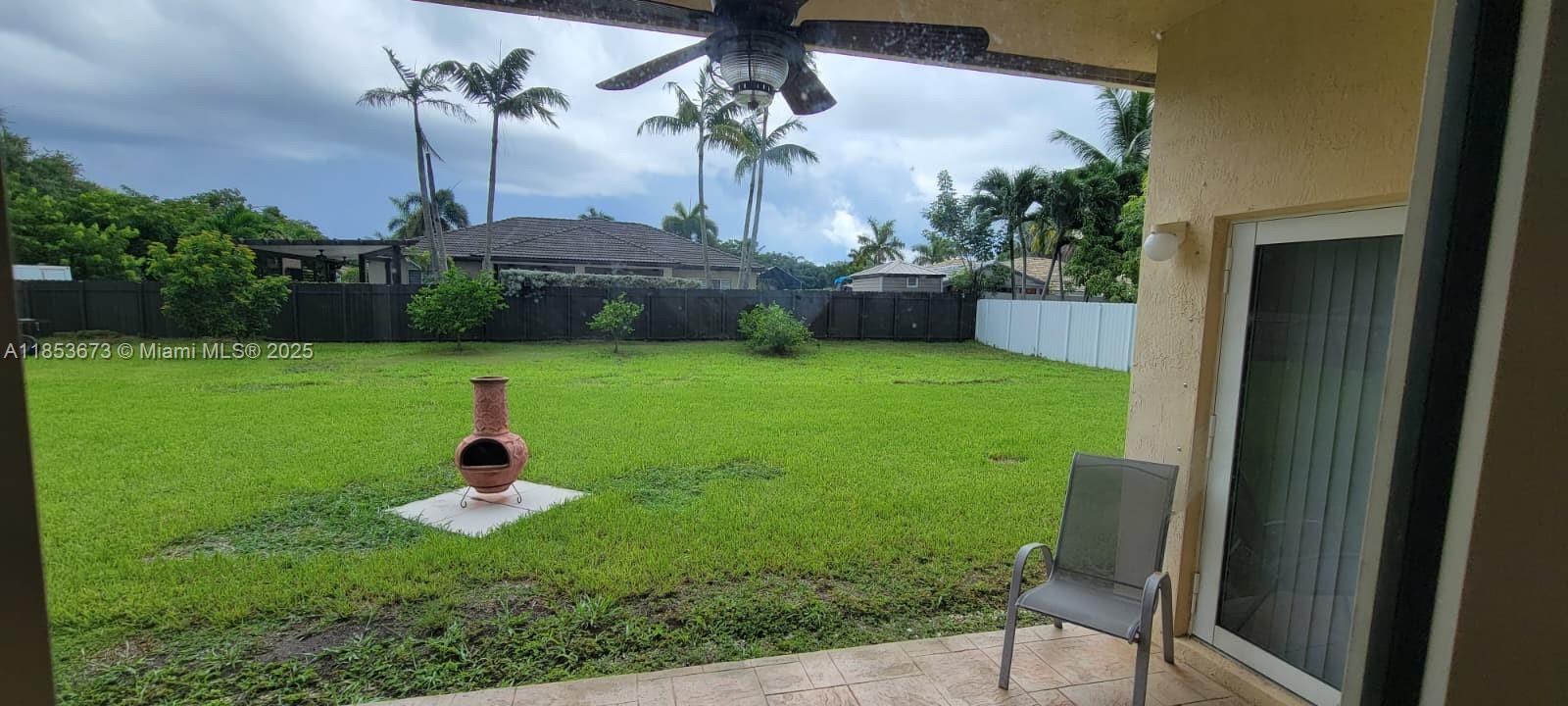 13281 Southwest 206th Terrace Miami, FL 33177 - Photo 15 of 18 a view of a chair and table in backyard of the house