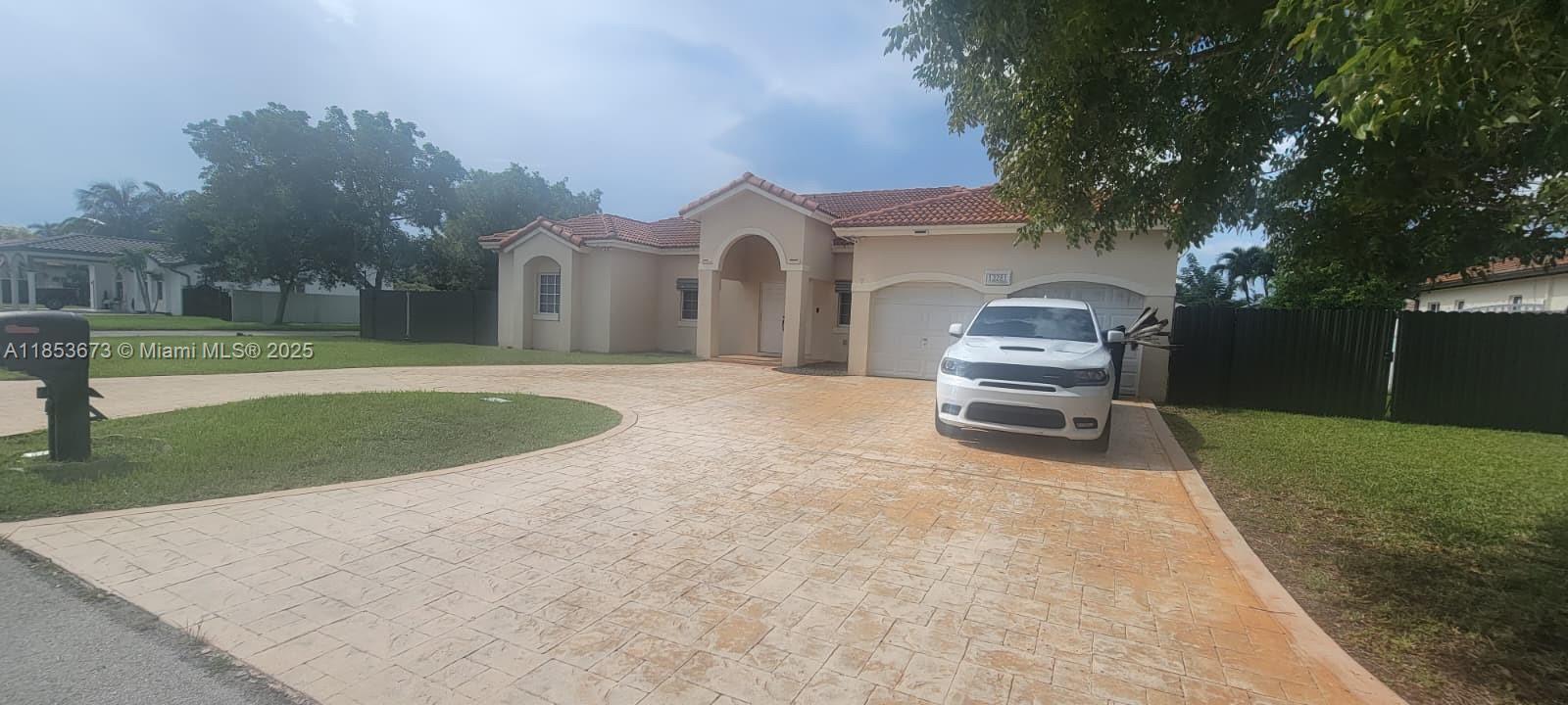 13281 Southwest 206th Terrace Miami, FL 33177 - Photo 2 of 18 a view of a house with a yard and sitting area