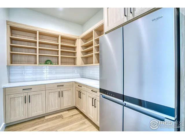 a kitchen with stainless steel appliances a refrigerator and cabinets