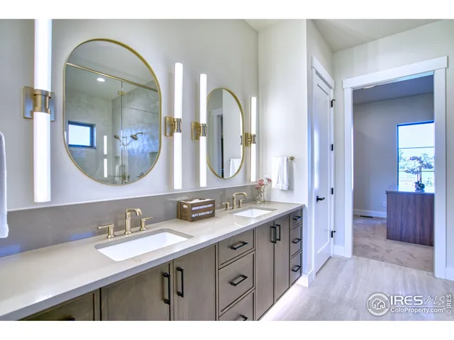 a bathroom with a double vanity sink and a mirror
