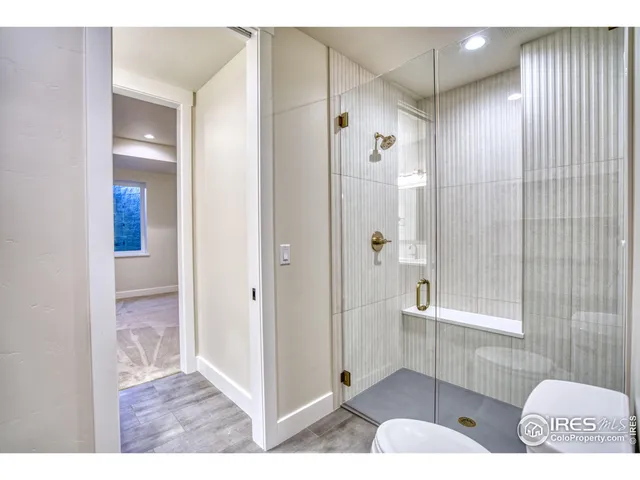 a bathroom with a granite countertop sink toilet and mirror