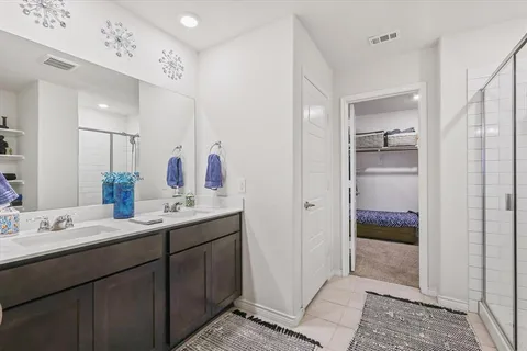 a en suite bathroom with a sink a mirror and a shower