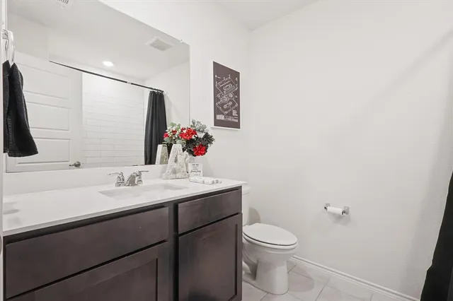 a bathroom with a sink vanity mirror and toilet