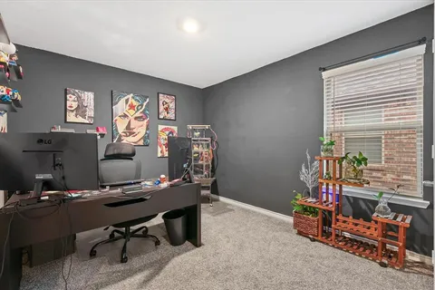 a view of a workspace with furniture and a window