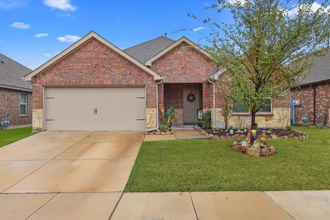 a front view of house with a garden