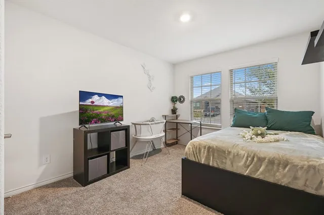 a bedroom with a bed and flat screen tv