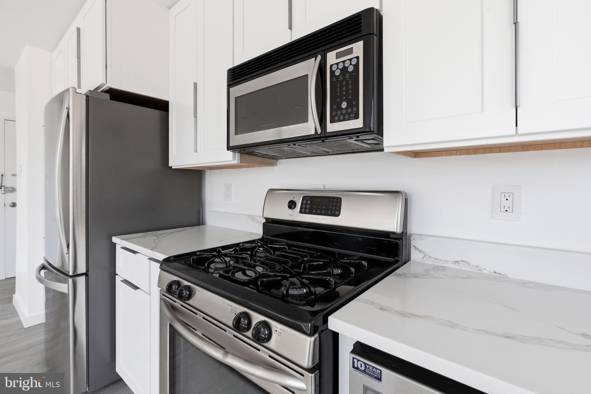 4000 Tunlaw Road Northwest, Unit 611 Washington, DC 20007 - Photo 22 of 29 Bright White Cabinets w/ Quartz Counters
