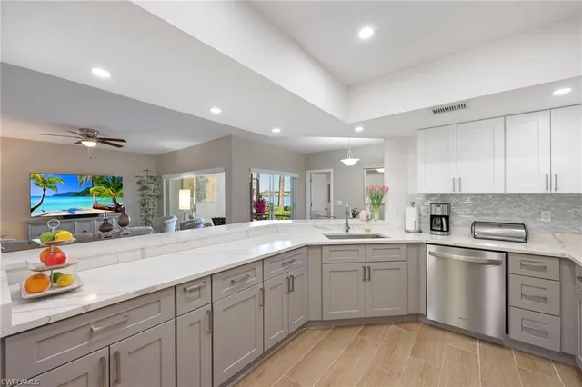 a kitchen with counter top space sink and cabinets