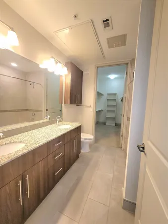 a large bathroom with a sink mirror and a shower