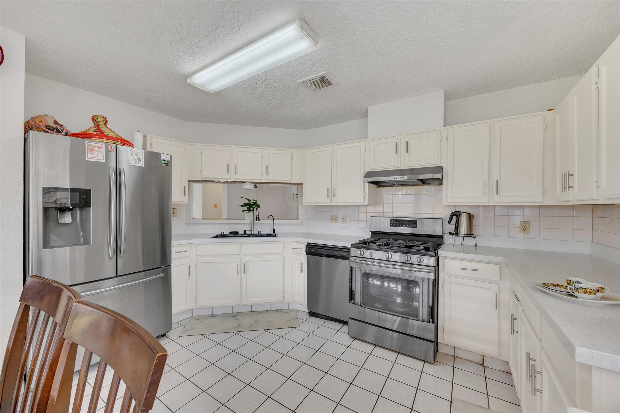 15619 Beechnut Street Houston, TX 77083 - Photo 14 of 29 Enjoy plenty of counter space, a gas range, and updated finishes—ideal for everyday cooking or entertaining.