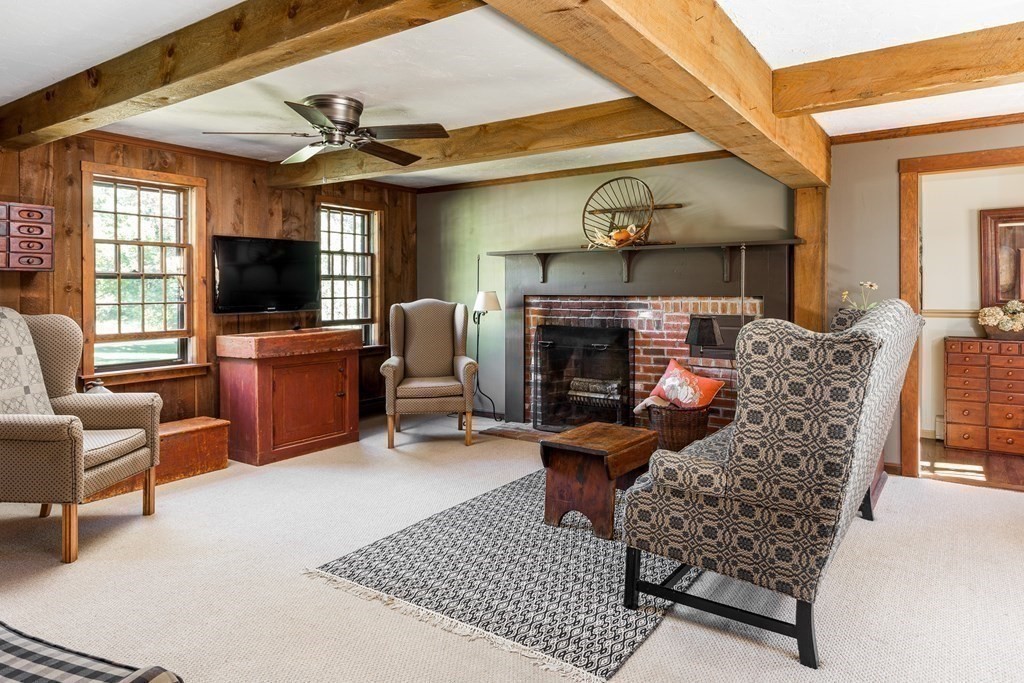 4 Chestnut Street Hopkinton, MA 01748 - Photo 11 of 40 a living room with furniture a flat screen tv and a fireplace