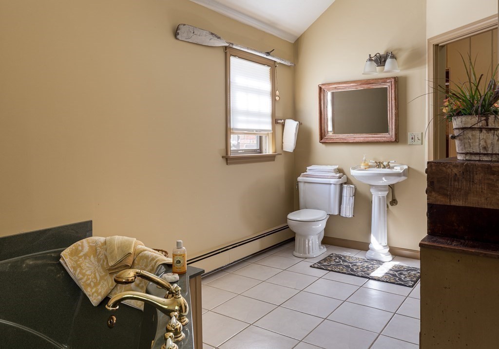 4 Chestnut Street Hopkinton, MA 01748 - Photo 18 of 40 a bathroom with a toilet sink and mirror