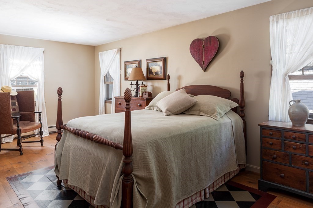 4 Chestnut Street Hopkinton, MA 01748 - Photo 19 of 40 a bedroom with a bed and a dresser with mirror