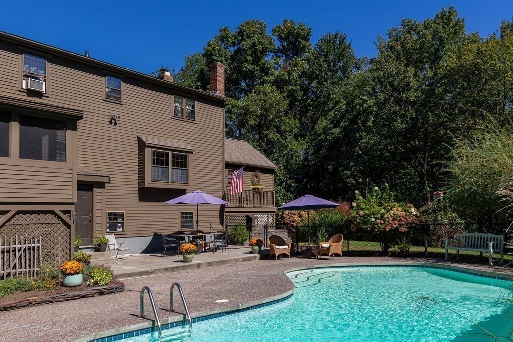 4 Chestnut Street Hopkinton, MA 01748 - Photo 30 of 40 a view of a patio with table and chairs under an umbrella