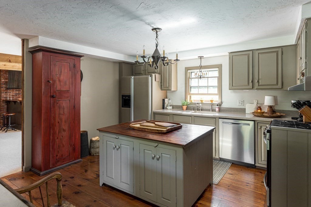 4 Chestnut Street Hopkinton, MA 01748 - Photo 8 of 40 a kitchen with kitchen island granite countertop a sink stove and refrigerator