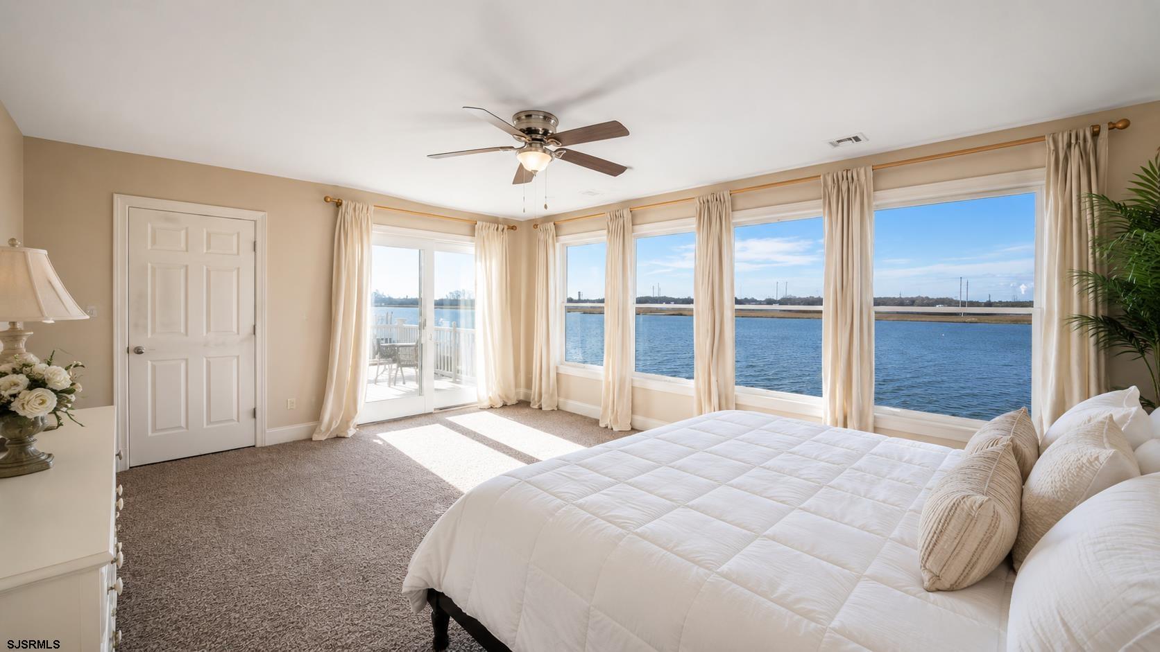 2070 West Riverside Drive Atlantic City, NJ 08401 - Photo 17 of 40 a bedroom with a large bed and a large window