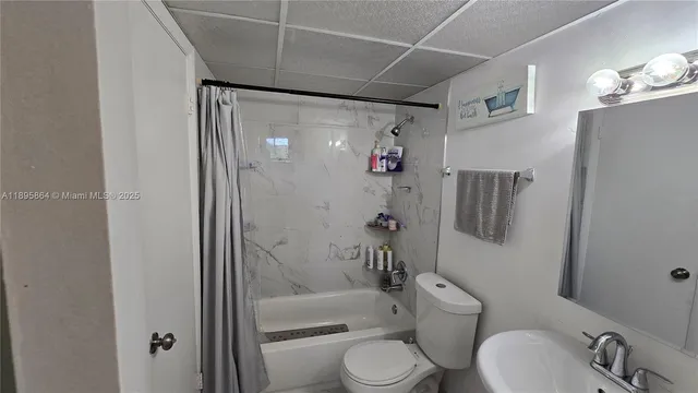 a bathroom with a toilet sink and shower