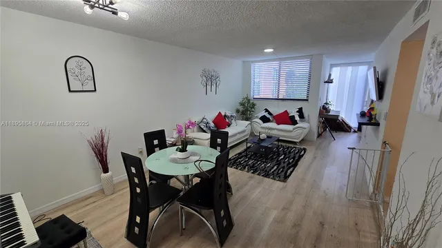 a view of a dining room with furniture and a chandelier