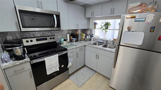 a kitchen with a stove microwave and sink
